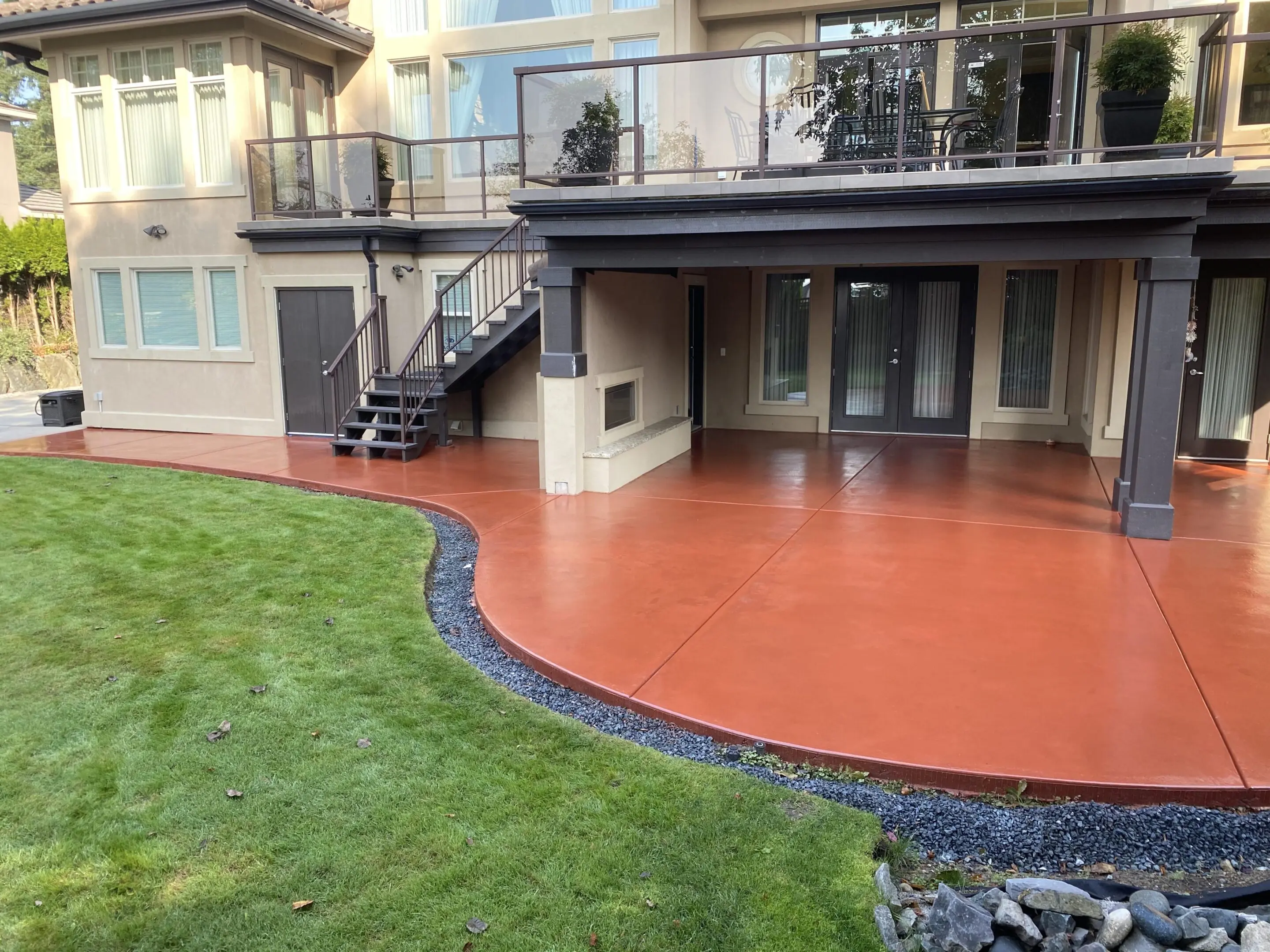 A patio with a fire hydrant and stairs leading to the deck.