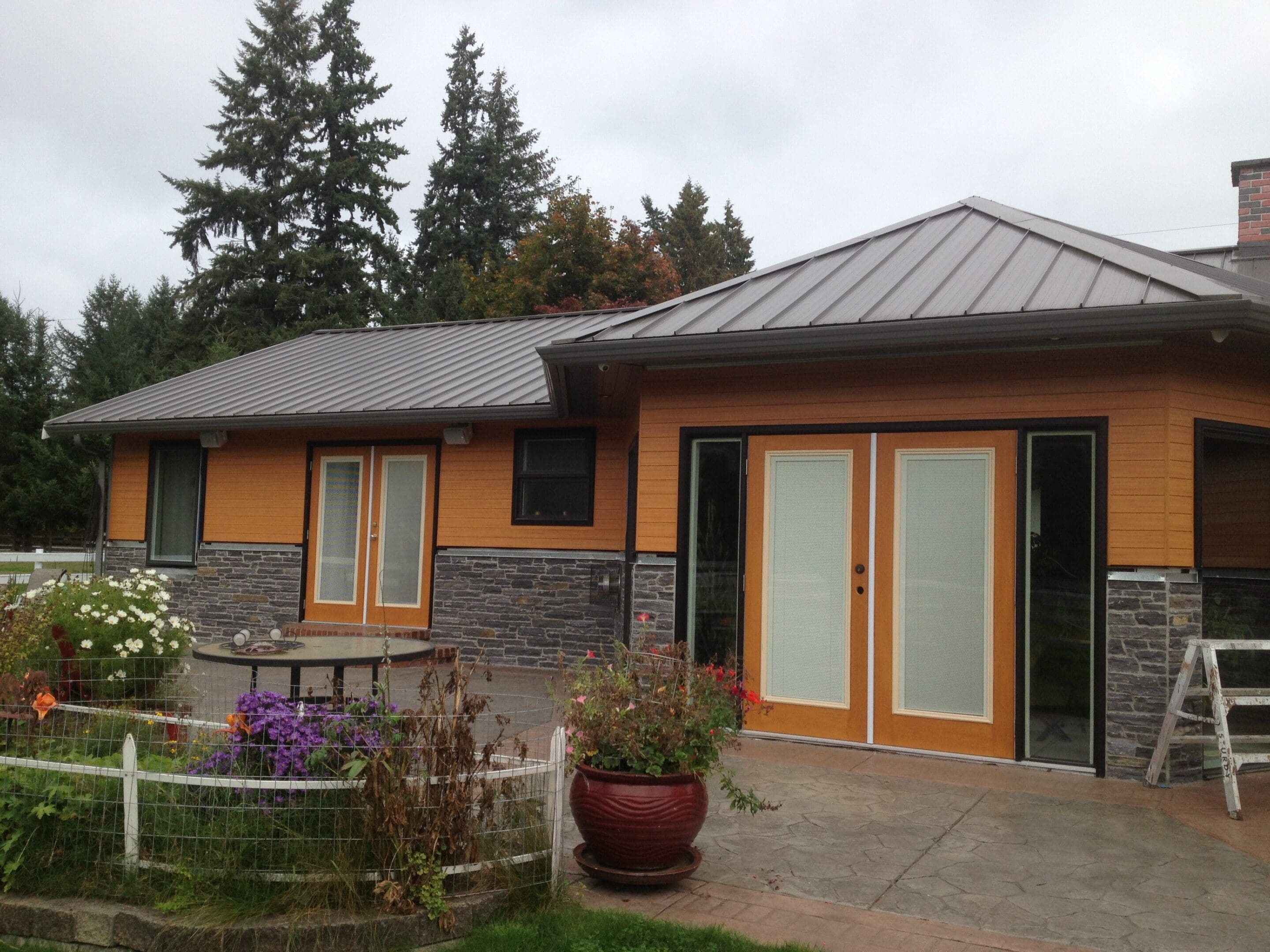 A house with a large patio area in front of it.