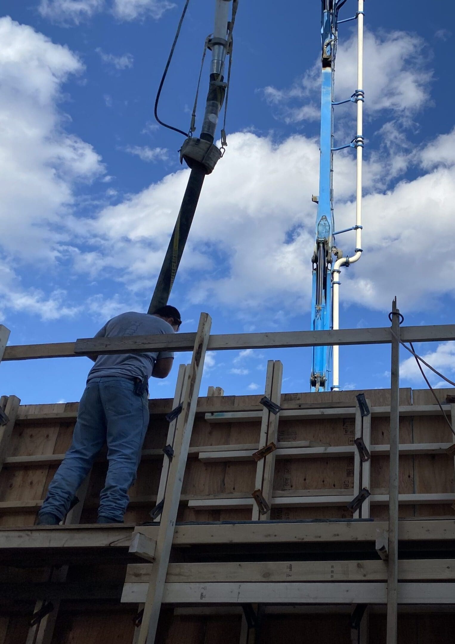 A man standing on top of a wooden structure.