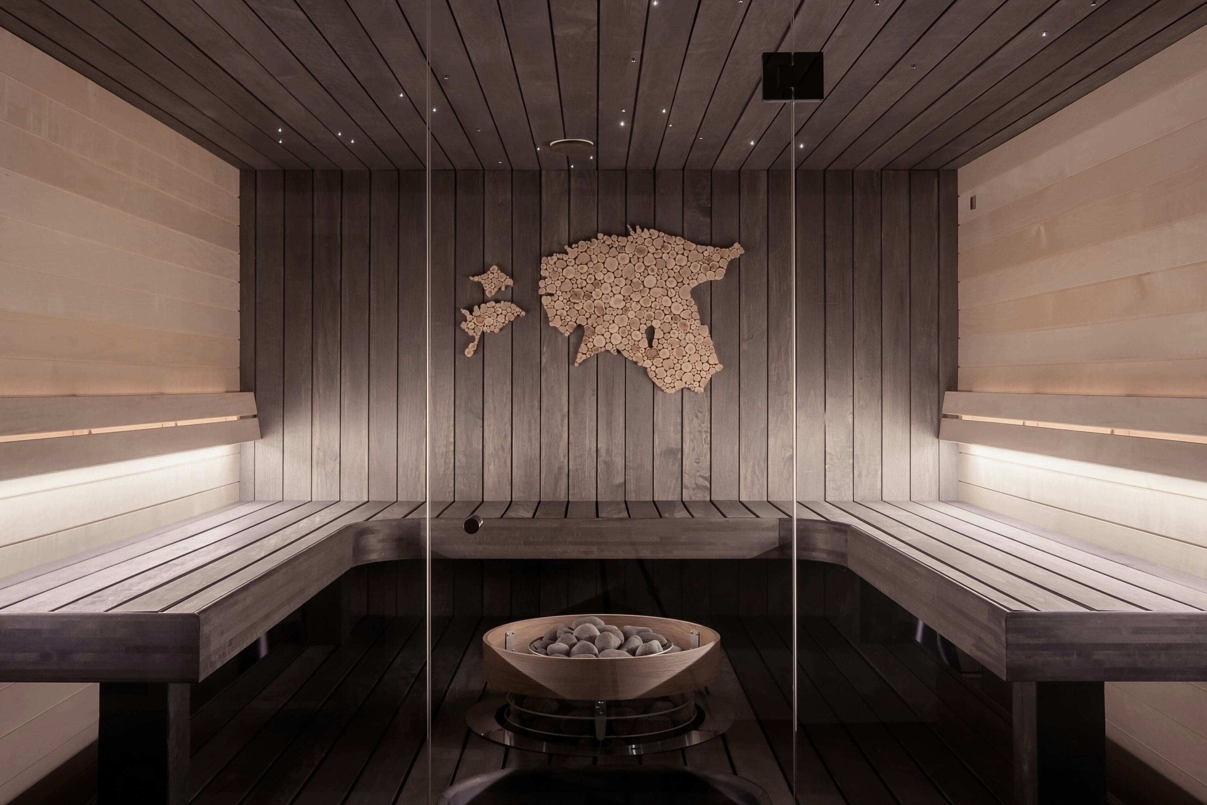 A wooden room with benches and a map on the wall.