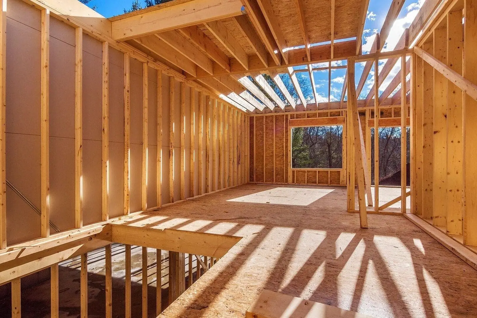 A wooden structure being built in the sun.