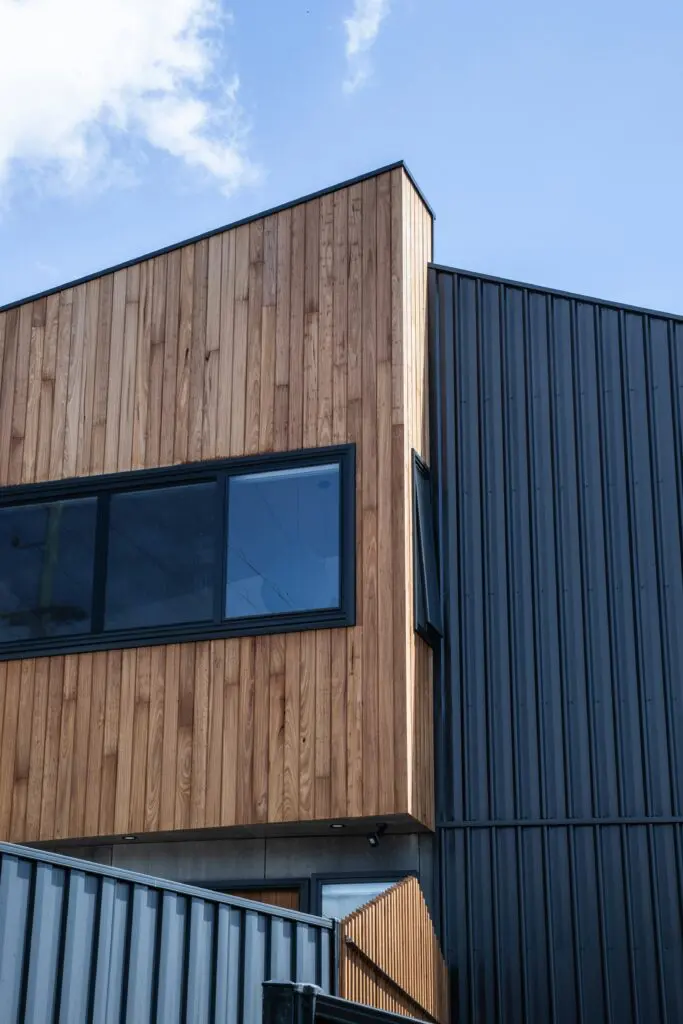 A building with wood siding and black metal trim.