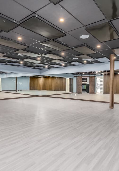 Spacious mirrored dance studio with modern design.